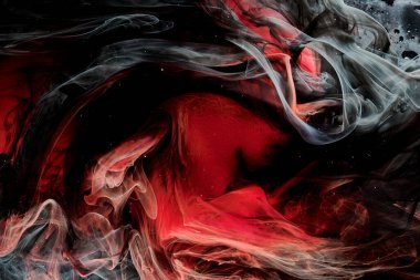 Red black abstract ocean background. Splashes and waves of paint under water, clouds of smoke in motion