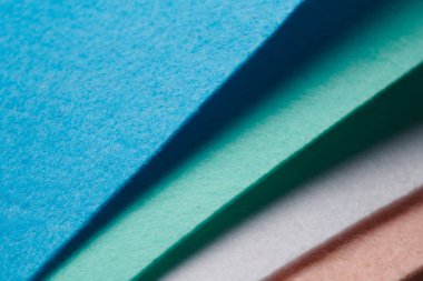 Multi-colored soft felt textile material, colorful patchwork texture fabric close-up