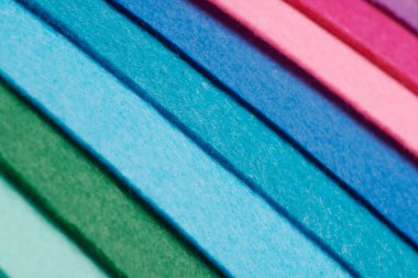 Multi-colored soft felt textile material, colorful patchwork texture fabric close-up