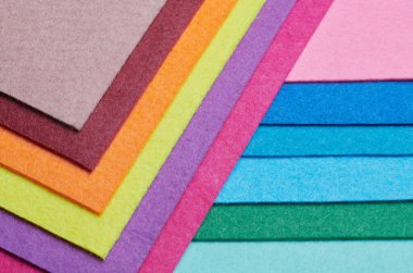 Multi-colored soft felt textile material, colorful patchwork texture fabric close-up