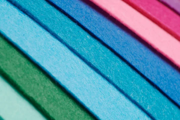 Multi-colored soft felt textile material, colorful patchwork texture fabric close-up