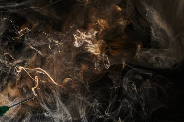 Black gold abstract ocean background. Splashes and waves of sparkling paint under water, clouds of interstellar smoke in motion