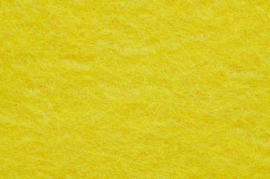 Soft felt textile material yellow color, colorful texture flap fabric background closeup
