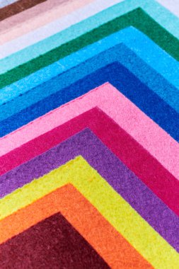 Multi-colored soft felt textile material, colorful patchwork texture fabric close-up