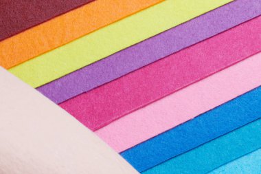 Multi-colored soft felt textile material, colorful patchwork texture fabric close-up