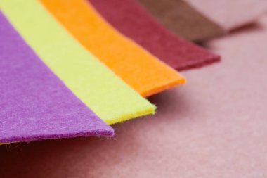 Multi-colored soft felt textile material, colorful patchwork texture fabric close-up