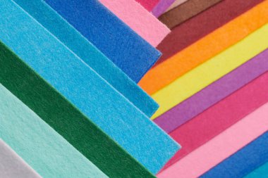 Multi-colored soft felt textile material, colorful patchwork texture fabric close-up