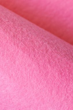 Soft felt textile material pink color, colorful texture flap fabric background closeup