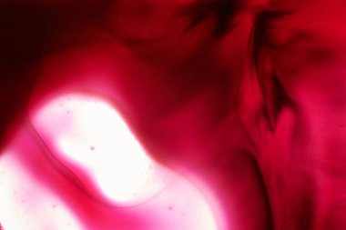 Abstract magenta background. Alcohol ink streaks and stains of wine color, paint splashes