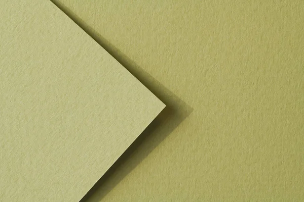 Rough kraft paper pieces background, geometric monochrome paper texture pale green color. Mockup with copy space for text