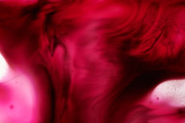 Abstract magenta background. Alcohol ink streaks and stains of wine color, paint splashes