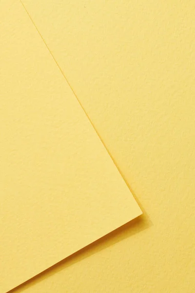 Rough kraft paper pieces background, geometric monochrome paper texture yellow color. Mockup with copy space for text