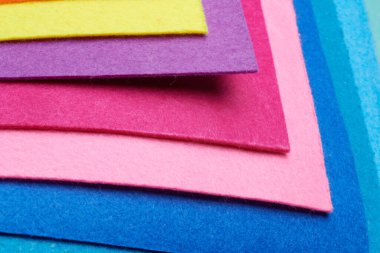 Multi-colored soft felt textile material, colorful patchwork texture fabric close-up