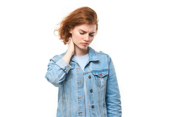 stock image Portrait redhead young woman with suffering face feels pain in her neck isolated on white studio background