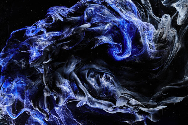 Dark blue abstract ocean background. Splashes, drops and waves of shining paint under water, clouds of smoke in motion