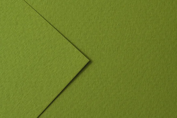 Rough kraft paper pieces background, geometric monochrome paper texture green color. Mockup with copy space for text