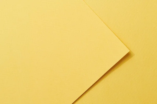 Rough kraft paper pieces background, geometric monochrome paper texture yellow color. Mockup with copy space for text