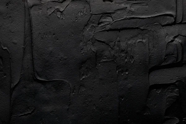 装飾的な黒パテの背景 ヘラで塗布されたフィラーペーストで壁のテクスチャ 混沌としたダッシュや石膏の上にストローク 創造的なデザイン 石のパターン セメント — ストック写真