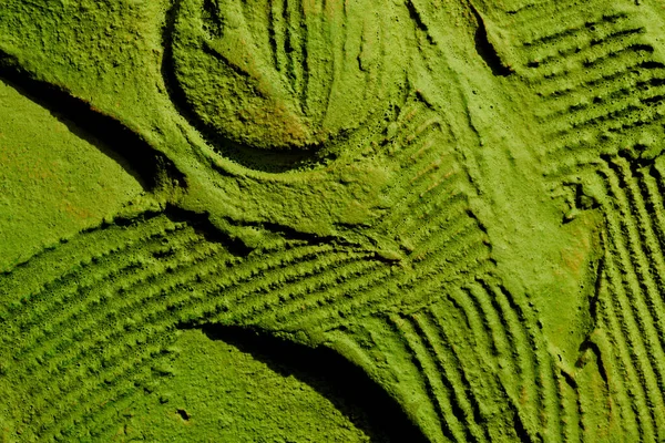 stock image Decorative green putty background. Wall texture with filler paste applied with spatula, chaotic dashes and strokes over plaster. Creative design, stone pattern, cemen