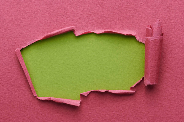 Frame of ripped paper with torn edges. Window for text with copy space red burgundy green colors, shreds of notebook pages. Abstract backgroun