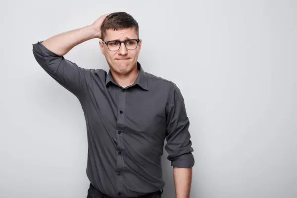 stock image Portrait of clever man in shirt touching head thinks doubts chooses isolated on white studio background with copy space