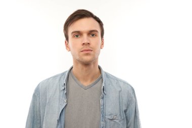 Beyaz stüdyo arka planında kopyalanmış ciddi yüz ifadesi olan beyaz bir adamın portresi.