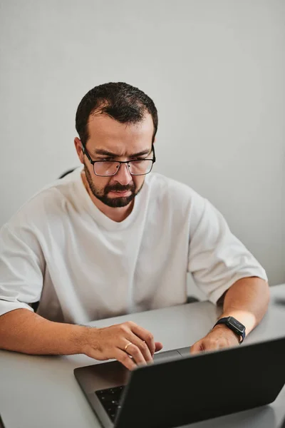 Portrait professional man programmer working concentrated on computer in diverse offices. Modern IT technologies, development of artificial intelligence, programs, applications and video games concep