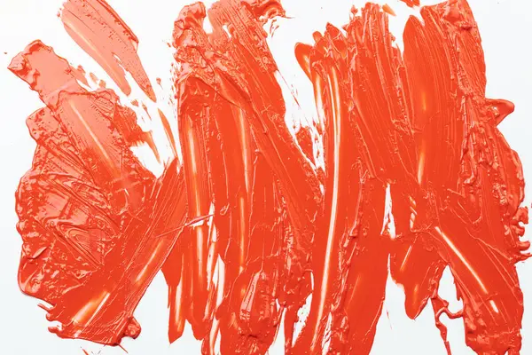 丙烯酸颜料斑斑 乱刷乱画 白纸背景上流淌斑斑 具有创意的橙色背景 流线型 — 图库照片