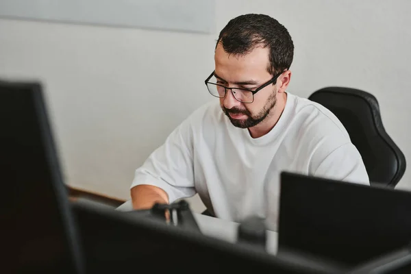 Portrait professional man programmer working concentrated on computer in diverse offices. Modern IT technologies, development of artificial intelligence, programs, applications and video games concep