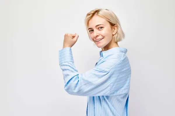 Portrait Confident Young Blonde Woman Showing Biceps Demonstrating Strength Isolated — Stock Photo, Image