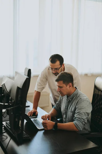 stock image Portrait of two professional male programmers working on computer in diverse offices. Modern IT technologies, development of artificial intelligence, programs, applications and video games concept