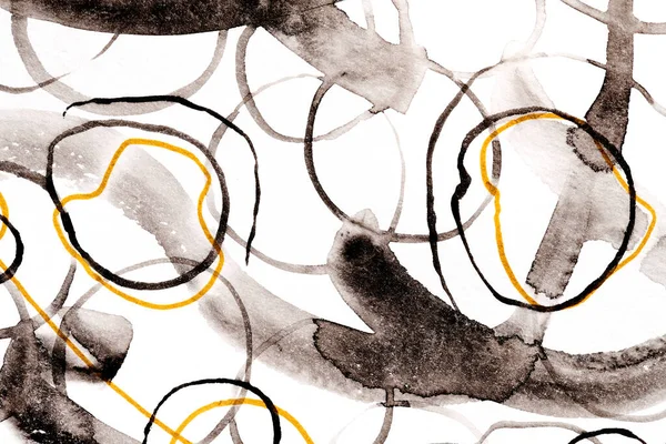 Abstract background. Black and yellow circles, brush strokes and paint spots on white paper, bright contrasting backdrop