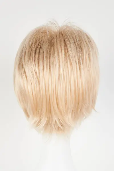 Natural looking blonde fair wig on white mannequin head. Short hair cut on the plastic wig holder isolated on white background, back vie
