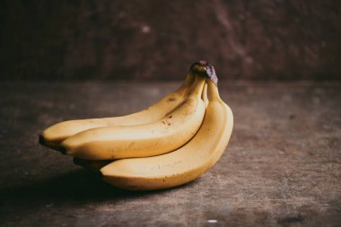 Kahverengi desenli arka planda bir grup muzun yakın çekimi