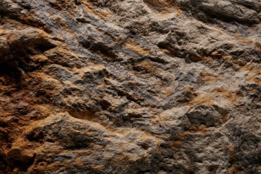 Kahverengi taş dokusu, koyu soyut arkaplan. Doğal mineral kaya detayları kapat, tasarım için kopya alanı olan boş arkaplan