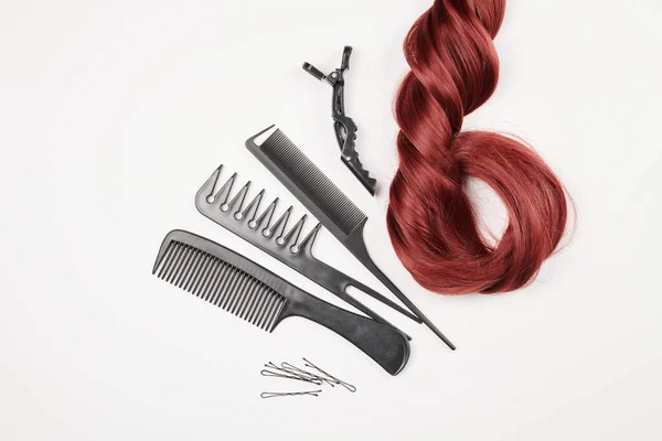 Hairdresser tools close-up isolated on white background. Hair curls and set of combs, clips, hairpins, hair beauty salon concept