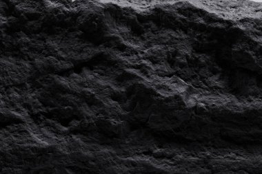 Siyah taş dokusu, koyu soyut arkaplan. Doğal mineral kaya detayları kapat, tasarım için kopya alanı olan boş arkaplan