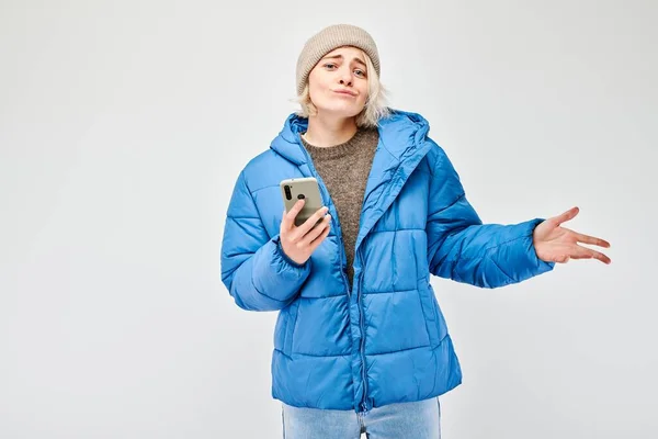 Portrait Young Blond Woman Blue Jacket Looks Mobile Phone Thinks — Stock Photo, Image