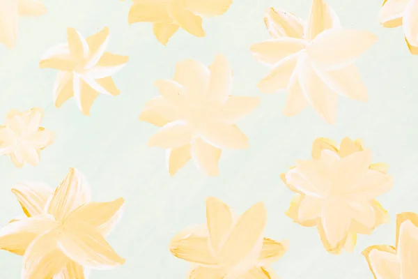 Yellow abstract flowers painted with paint on light blue paper