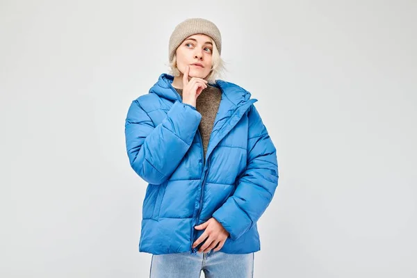 Woman Winter Attire Pensive Expression Thinks Chooses Isolated Light Background — Stock Photo, Image