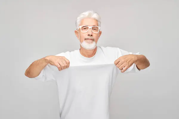 Starszy Mężczyzna Białej Koszulce Celujący Siebie Uśmiechem Szarym Tle — Zdjęcie stockowe