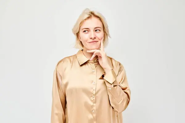 Confident Woman Satin Blouse Smiling Hand Her Chin Light Background — Stock Photo, Image