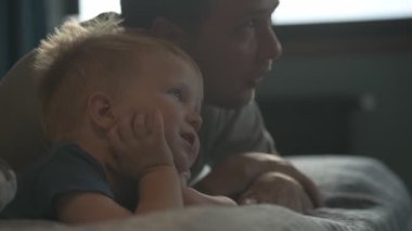 Mutlu aile babası ve küçük oğlu evde birlikte vakit geçirir, oyunlar oynar ve çizgi film izlerler.