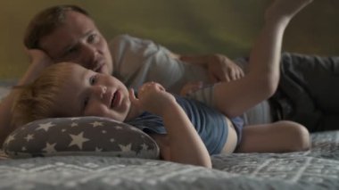 Mutlu aile babası ve küçük oğlu evde birlikte vakit geçirir, oyunlar oynar ve çizgi film izlerler.