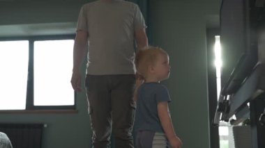 Mutlu aile babası ve küçük oğlu evde birlikte vakit geçirir, oyunlar oynar ve çizgi film izlerler.