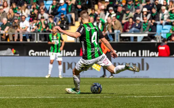 April 21th, 2024: Number 4 in GAIS, Axel Noren shooting a free kick from own half during game against Mjallby AIF.