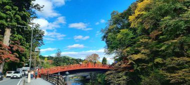 Autumn landscape with trees and leaves at the famous Shinky Bridge, Nikko, Japan.  clipart