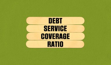 DSCR Symbol. Concept word DSCR Debt Service Coverage Ratio on beautiful wooden stick. Beautiful Green Chart Paper Background. Business and DSCR Debt Service Coverage Ratio concept. Copy space clipart