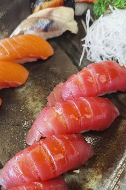 Seramik tabakta taze suşi ve Japon yemeği.