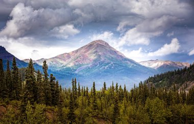 Dramatic louds above the mountain peaks of the Denali National Park, Alaska clipart